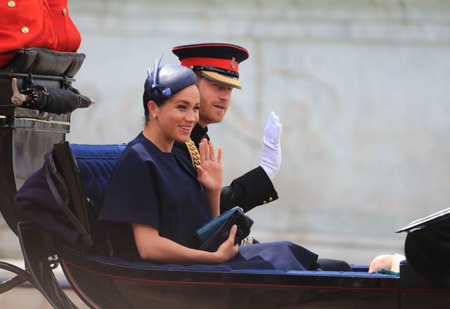 The Duke and Duchess of Sussex make their way along The Mall to Horse Guards Parade