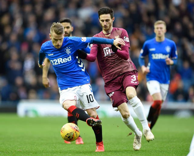 Steven Davis, left, and St Johnstone's Scott Tanser battle for the ball 