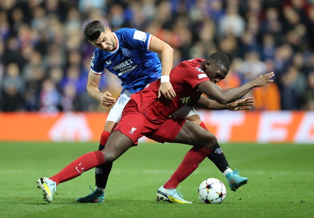 Ibrahima Konate, front, battles for possession against Rangers