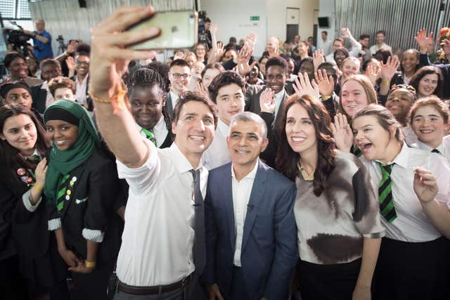 Justin Trudeau takes a selfie with Sadiq Khan and Jacinda Ardern (Stefan Rousseau/PA)