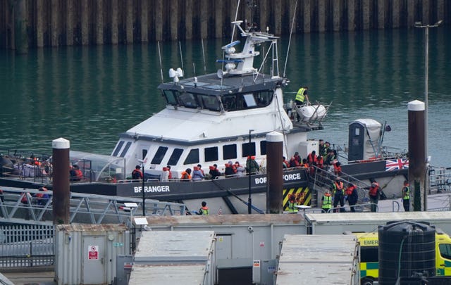 A group of people thought to be migrants are brought in to the Border Security Command