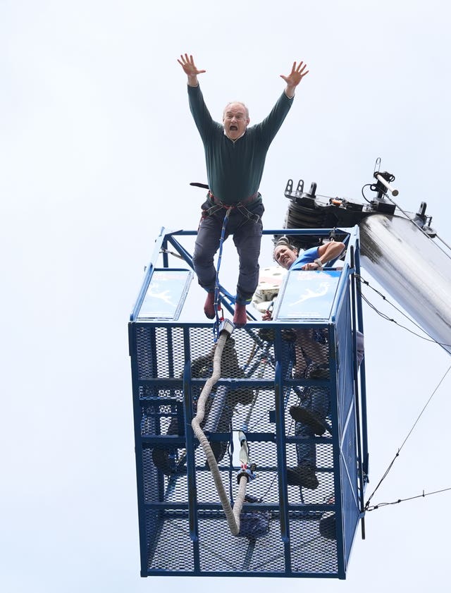 Liberal Democrat leader Sir Ed Davey taking part in a bungee jump