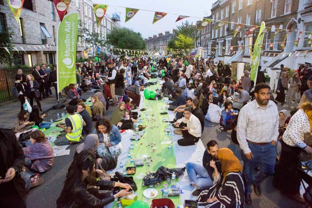 Hundreds sit and eat during the gathering