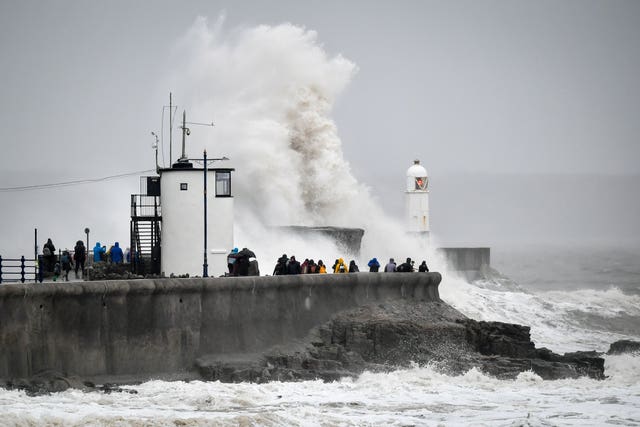 Waves pound against the harbour wall at Porthcawl, Wales