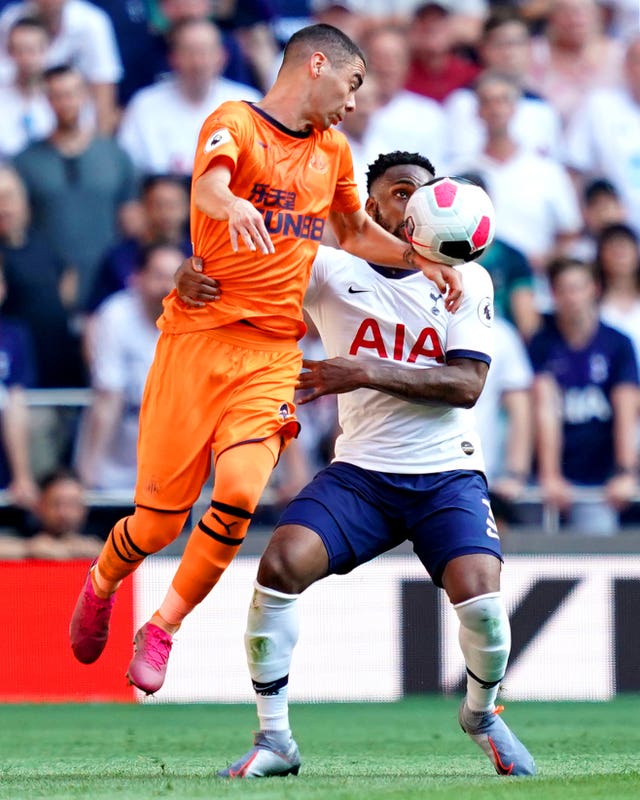 Newcastle's Miguel Almiron and Tottenham's Danny Rose battle for the ball 