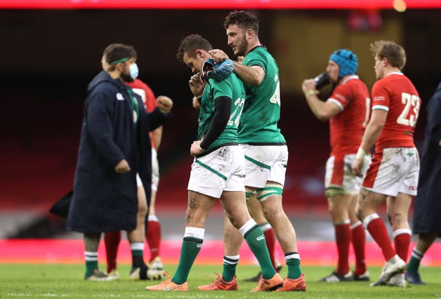 Ireland’s Billy Burns was consoled by team-mates following defeat to Wales