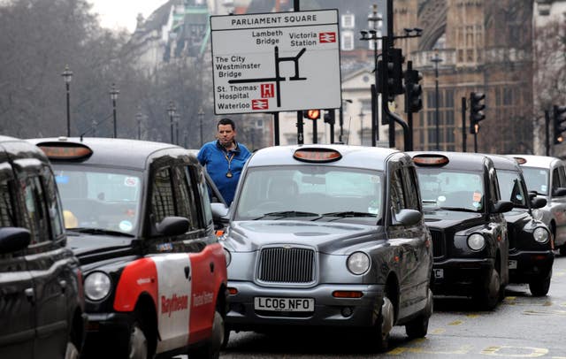 Taxi drivers line the street in Whitehall, London
