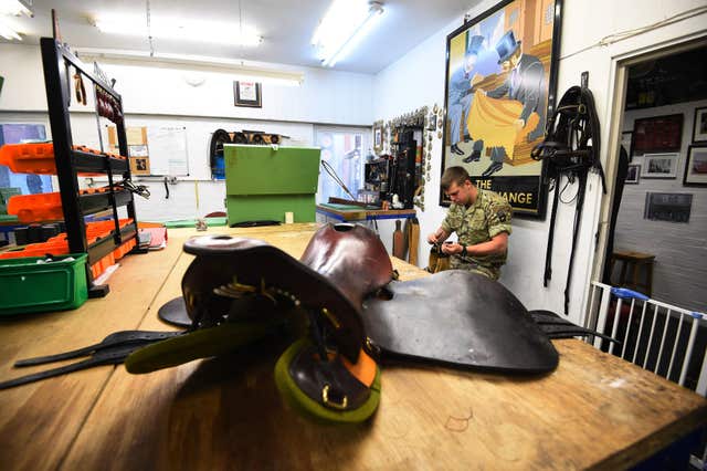 A member of the Household Cavalry hard at work getting things ready in the Saddlers Shop (Kirsty O’Connor/PA)