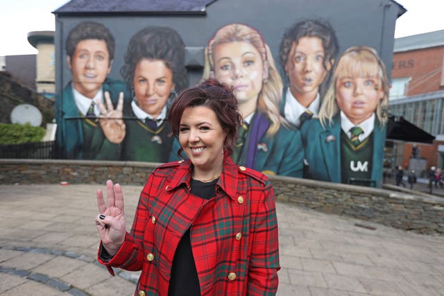 Lisa McGee in front of the Derry Girls mural in her home city