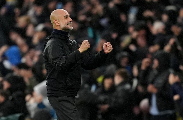 Manchester City manager Pep Guardiola celebrates on the touchline