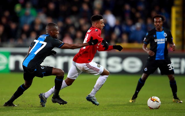 Jesse Lingard (centre) and Clinton Mata (left) battle for the ball 