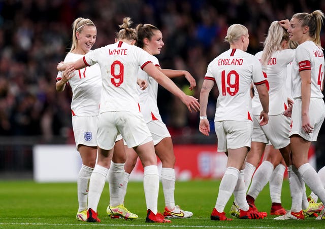 Beth Mead, left, celebrates her first goal