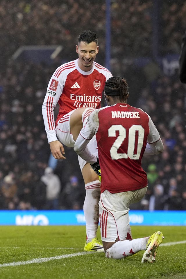 Noni Madueke, right, pretends to polish the right boot of Gabriel Martinelli after the latter's third goal against Portsmouth