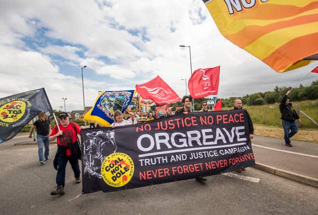 Protesters hold a banner calling for a public inquiry over the Battle of Orgreave