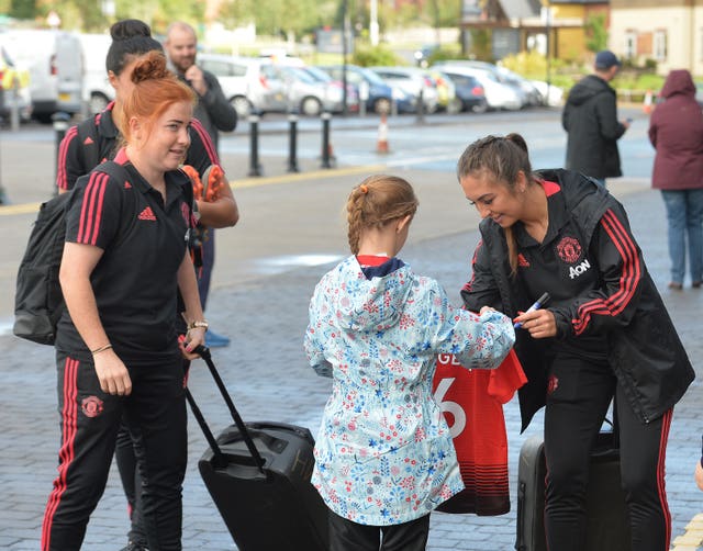 Katie Zelem signs autographs before a game