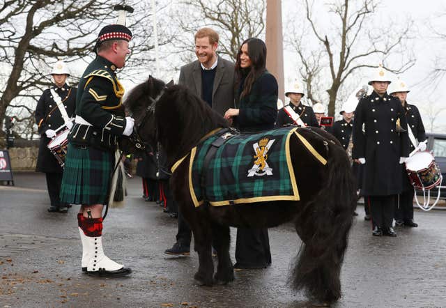 Prince Harry and Meghan Markle meet Pony Major Mark Wilkinson and regimental mascot Cruachan IV (Andrew Milligan/PA)