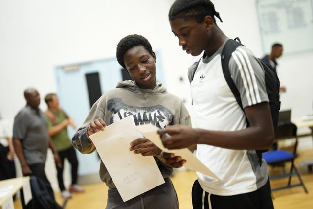 Pupils collect their GCSE results at a school in Woolwich, south London