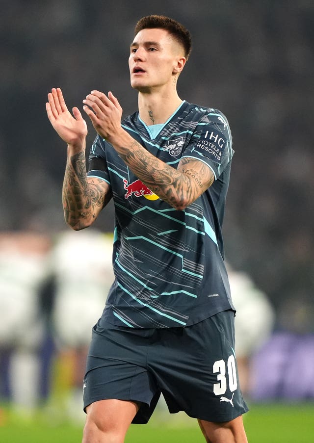 Benjamin Sesko claps while in action for Leipzig