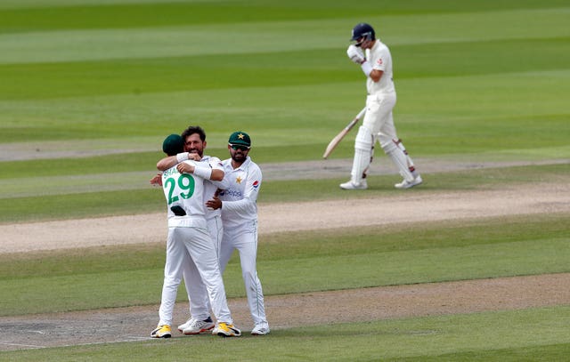 Dom Sibley, right, leaves the field as Pakistan celebrate taking his wicket