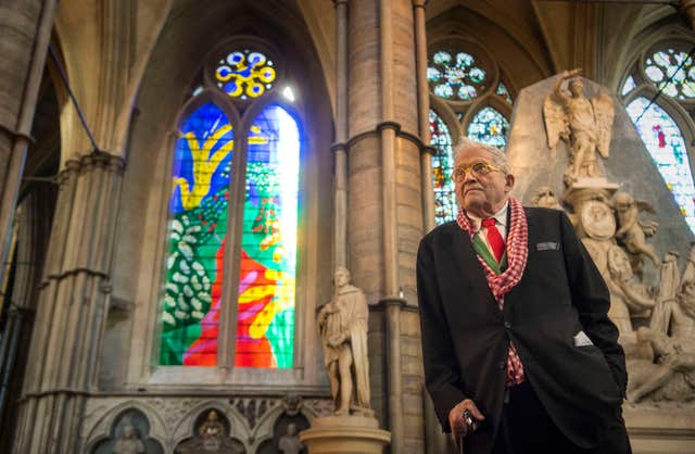 David Hockey standing next to his The Queen’s Window design