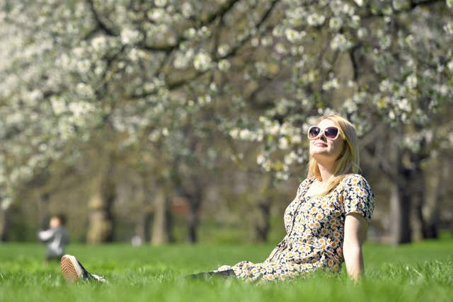 A woman enjoys the sun at St James’ Park, London (Victoria Jones/PA)