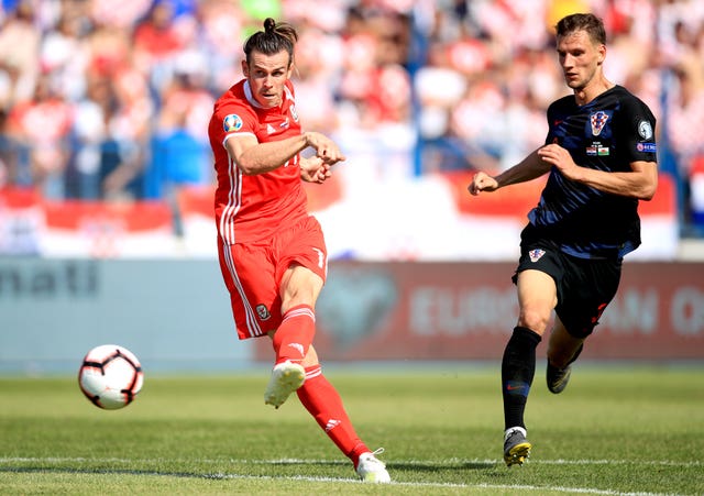 Gareth Bale (left) fires goalwards but without luck in Osijek