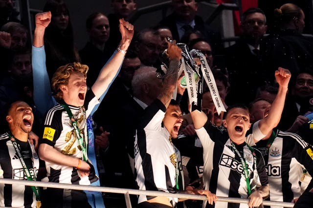 Newcastle’s Bruno Guimaraes and Kieran Trippier hold aloft the Carabao Cup after final victory over Liverpool