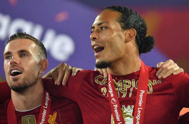Virgil Van Dijk, right, and Jordan Henderson celebrate winning the Premier League title