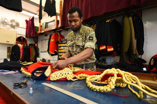 A member of the Household Calvary works at Hyde Park Barracks during the Household Cavalry Mounted Regiment preparations for the royal wedding (Kirsty O'Connor/PA)