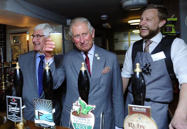 Charles holding a pint he's just pulled in the George & Dragon Inn in Hudswell near Richmond, Yorkshire in 2015
