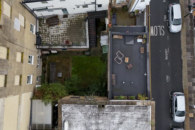 A view of the shared back garden of two neighbouring properties on Bethnal Green Road (Jordan Pettitt/PA)