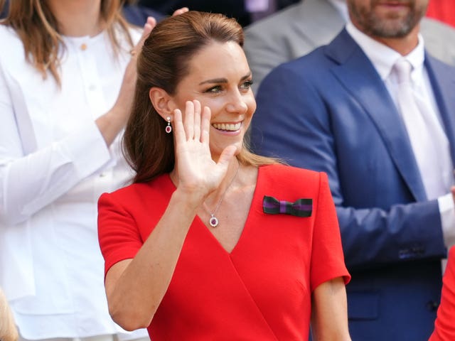 Kate waves from the royal box