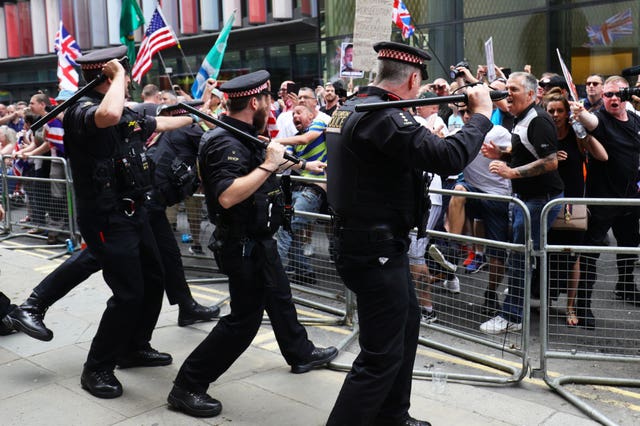 Supporters of Tommy Robinson face off with police outside the Old Bailey in London (Aaron Chown/PA)