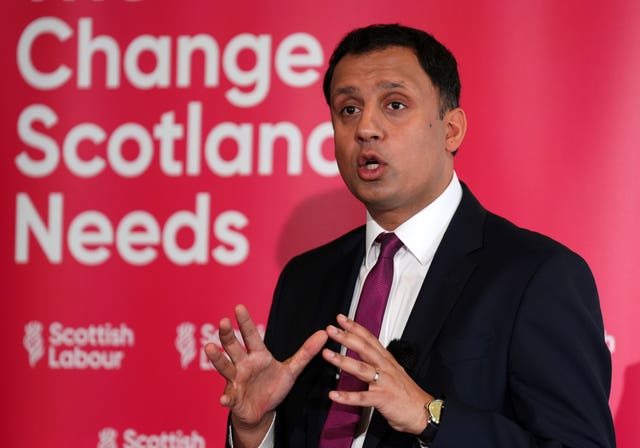 Anas Sarwar delivering a speech in front of Labour signage