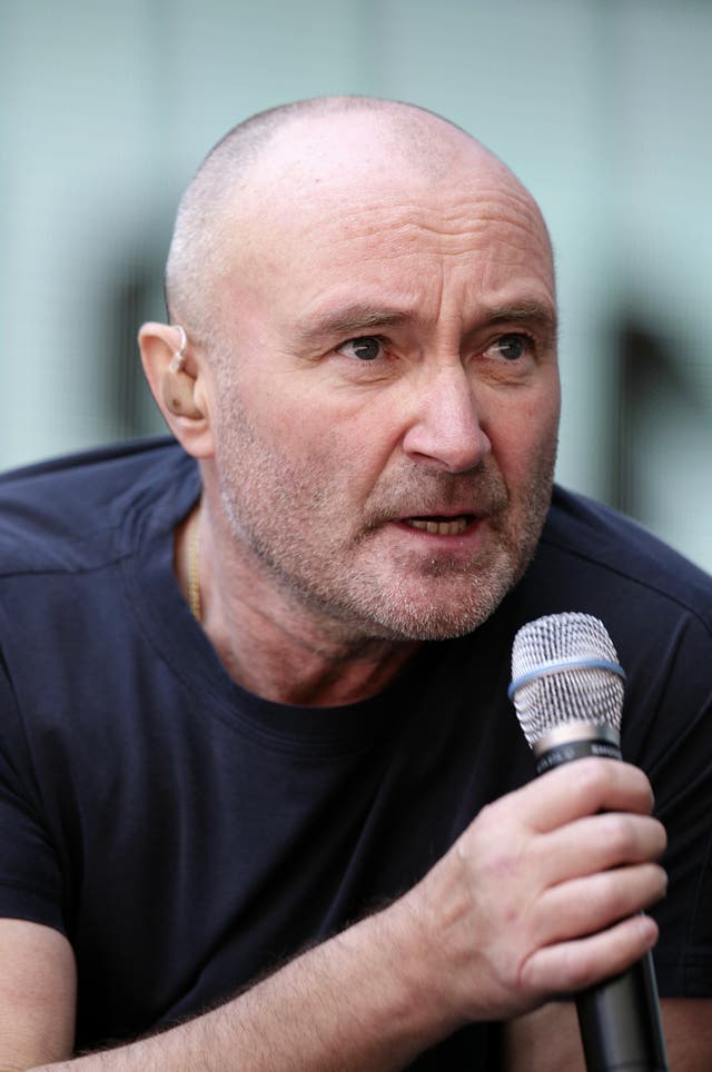 Phil Collins on stage during a performance with Genesis