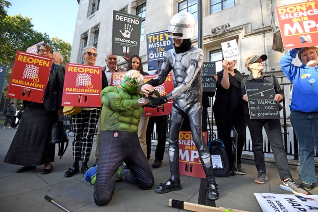 Protesters dressed as the Incredible Hulk and Robocop outside the Supreme Court