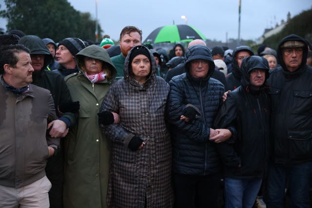 A crowd of people forming a blockade on a road