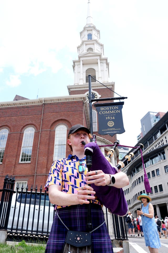 Scotland fan Simon Morley playing bagpipes outside Park Street Church in Boston