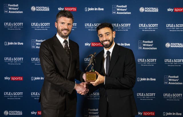 Bruno Fernandes is presented the Footballer of the Year trophy by Manchester United manager Michael Carrick