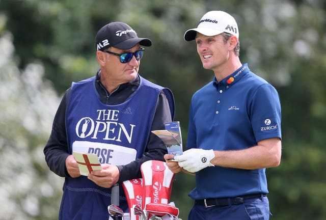Justin Rose speaks with caddie Mark Fulcher during The Open in 2017