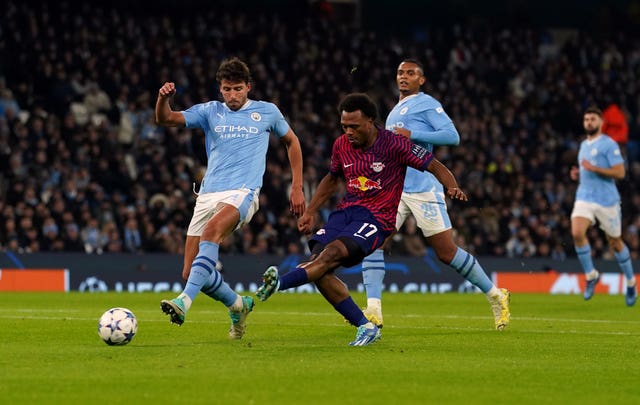 Lois Openda, centre, fires Leipzig in front