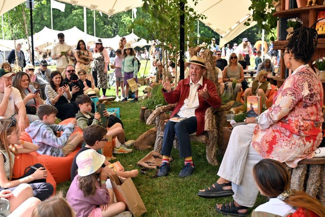 Author Sir Michael Morpurgo gives a talk to guests in literary corner