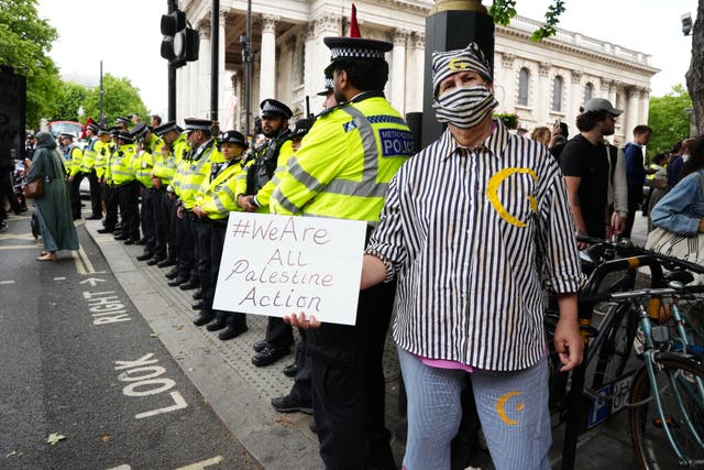 Police officers and protesters during a demonstration in support of Palestine Action