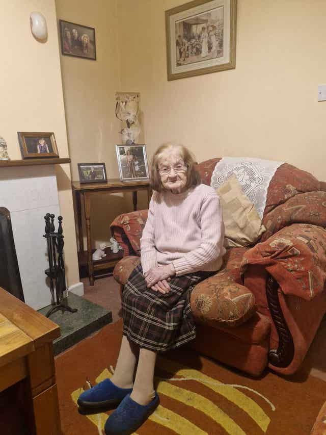 Chrissie Tully sat in a chair at her home