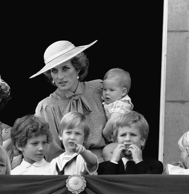 The Princess of Wales holding Harry with William (centre) on the balcony of Buckingham Palace (PA)