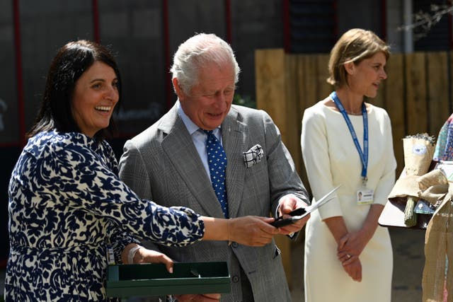 Charles prepares to cut the ribbon