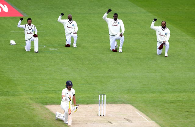 England's Rory Burns joins the West Indies in taking a knee.