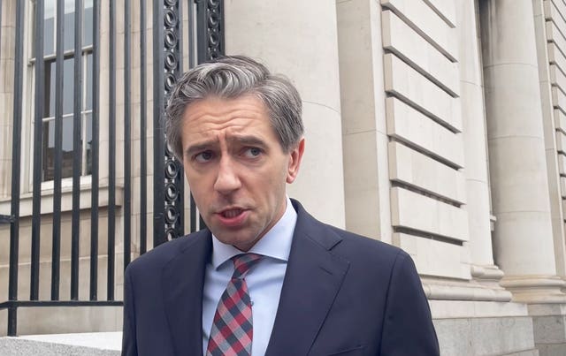 Taoiseach Simon Harris speaking to the media outside Government Buildings in Dublin