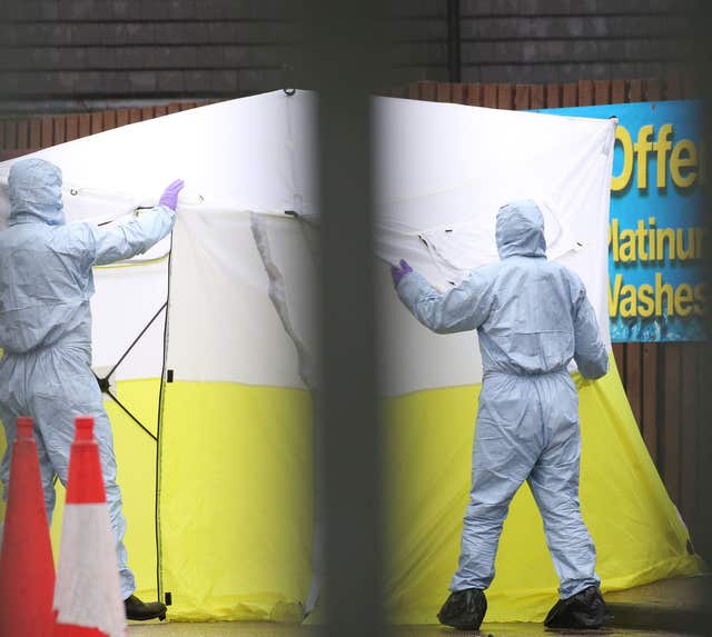 Forensic officers and a police tent at an Esso petrol station in Collier Row Road, Romford after a man was shot dead by police (Isabel Infantes/PA)