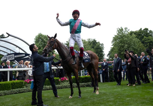 Frankie Dettori with his trademark flying dismount from Enable